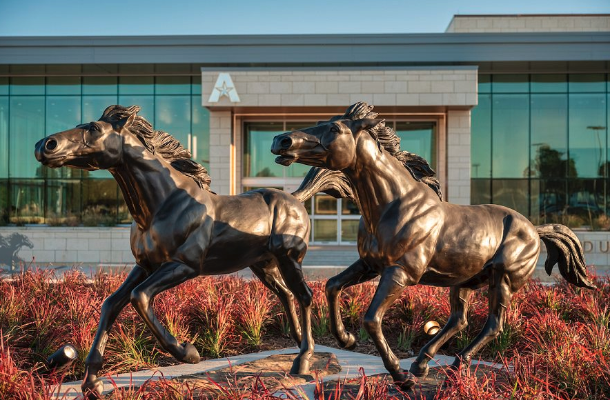 two statues in front of UC entrance